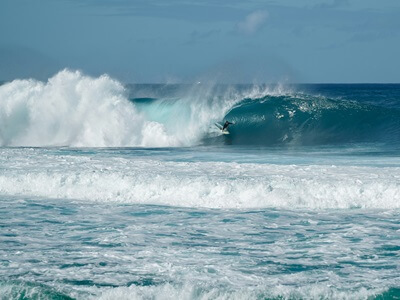 Surfer inside of the barrel of a wave at the famous Banzai Pipeline on the north shore of Oahu Hawaii.